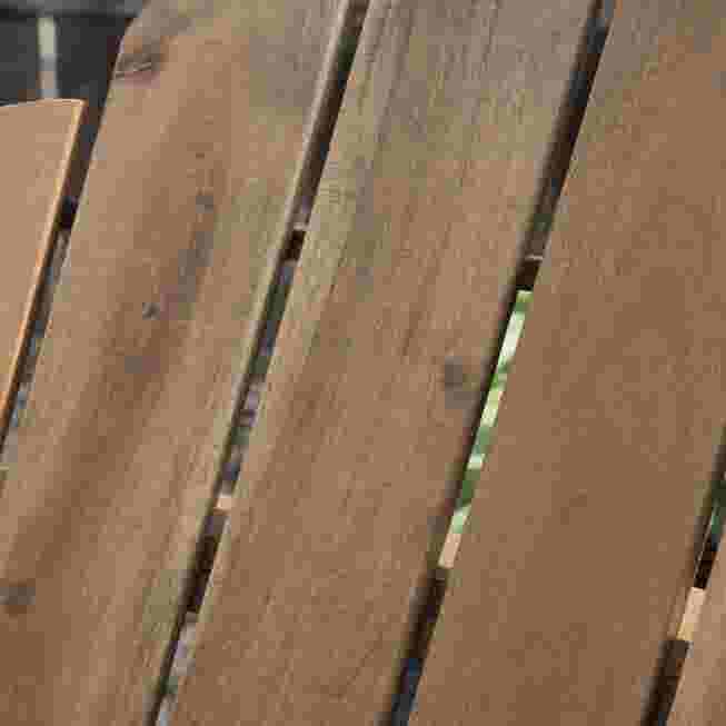 Close-up of the wooden slats on an Adirondack chair.