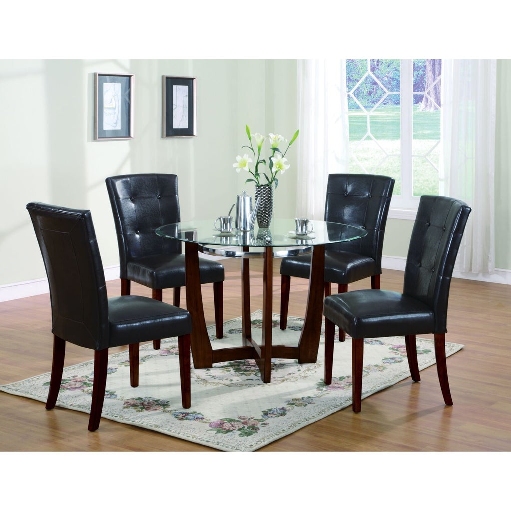 Six brown leather dining chairs around a glass table in dining room