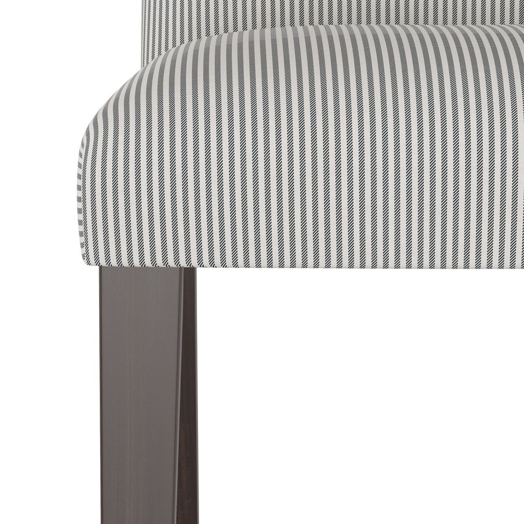 Close-up of striped upholstery fabric on chair edge.
