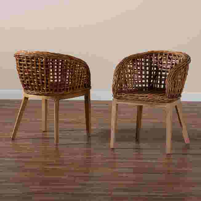 Two wicker dining chairs on a wooden floor