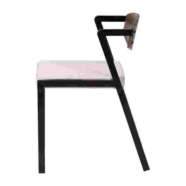 a side view of a dining chair with a fabric seat and metal frame