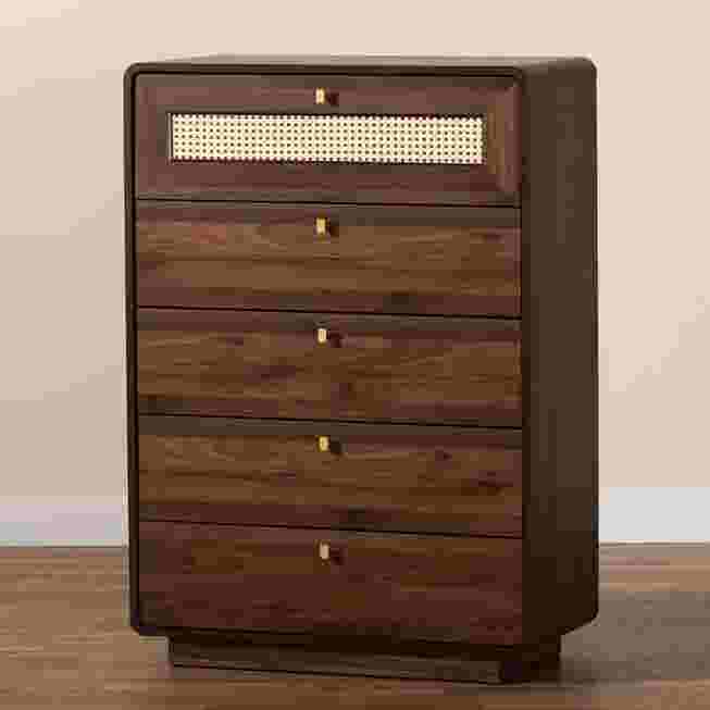 A dark wood chest with a rattan drawer front, placed in a room with a wooden floor.