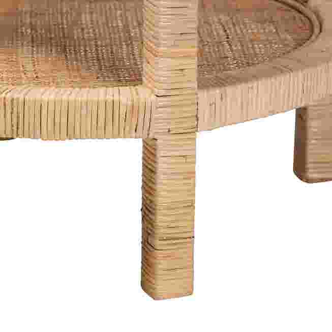 A close-up of the leg and woven texture of a round end table.