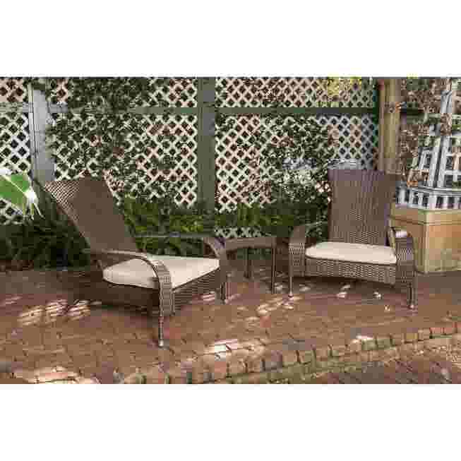 Two dark wicker chairs with light cushions and a table on a patio