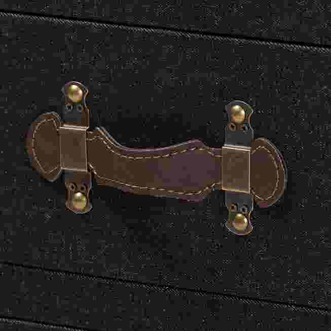Close-up of the drawer handle on a black canvas end table