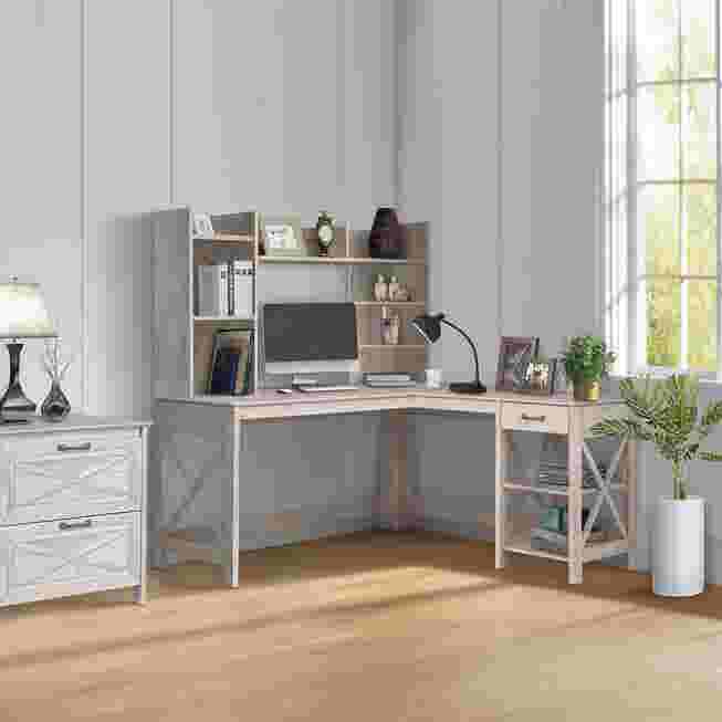L-shaped desk with a drawer and open shelf in a light gray finish