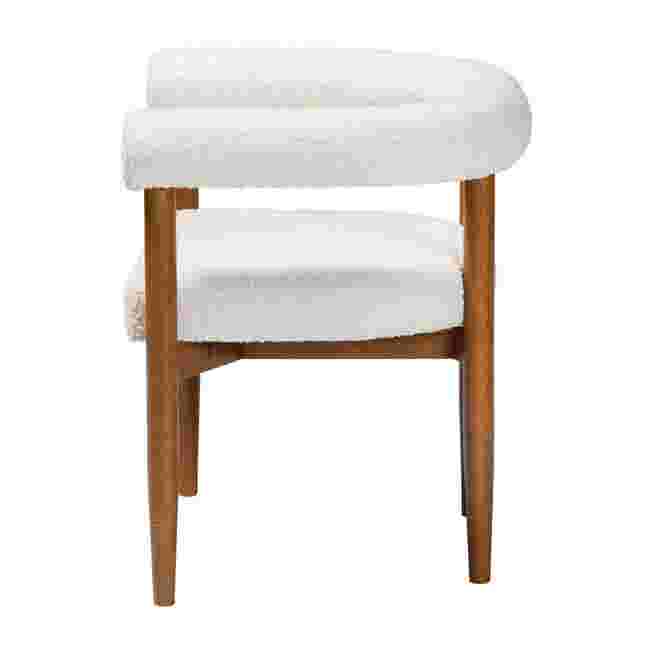 Side view of a white boucle dining chair with wooden legs