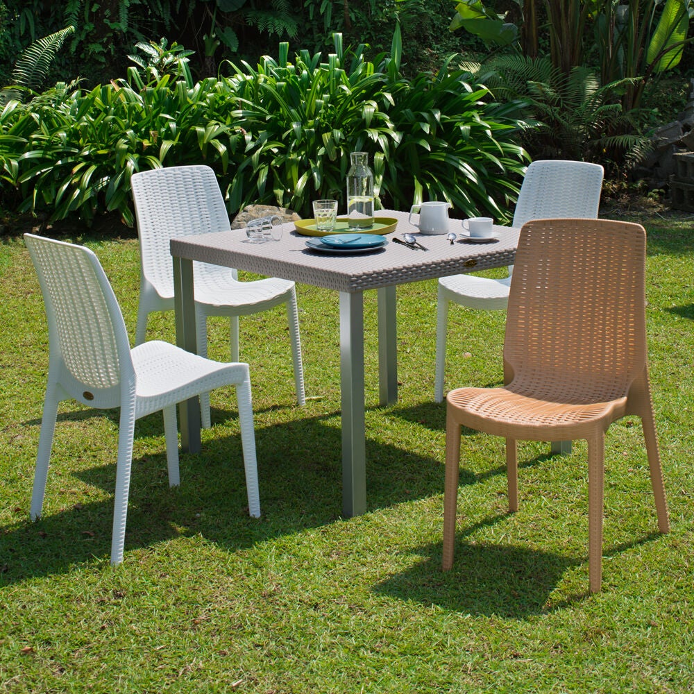 Rue outdoor dining chairs set shown around a table in a garden.