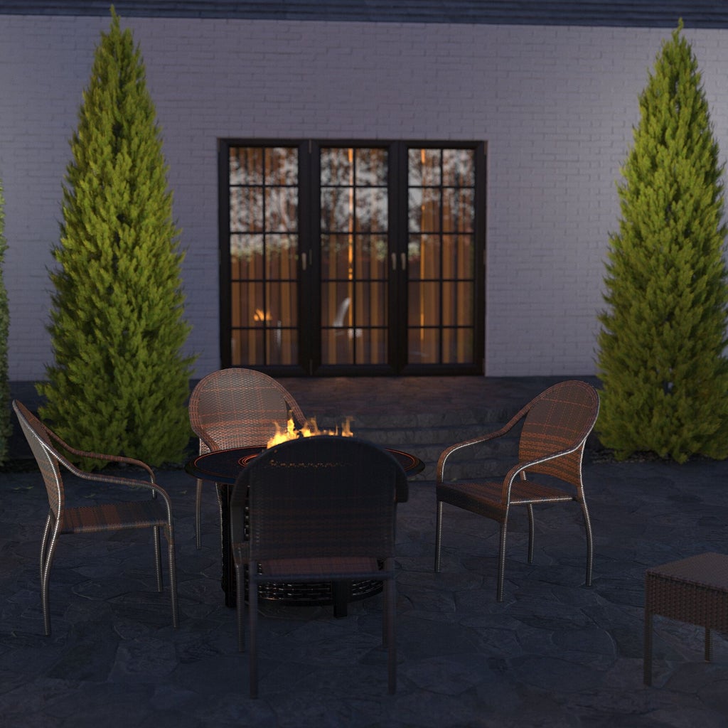 Outdoor seating area with four chairs around a fire table