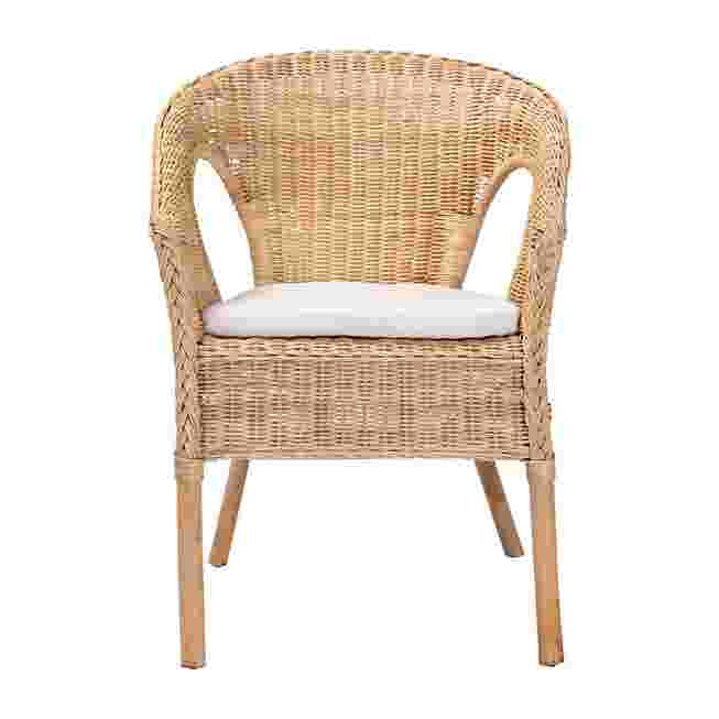 Natural rattan dining chair with white cushion on white background
