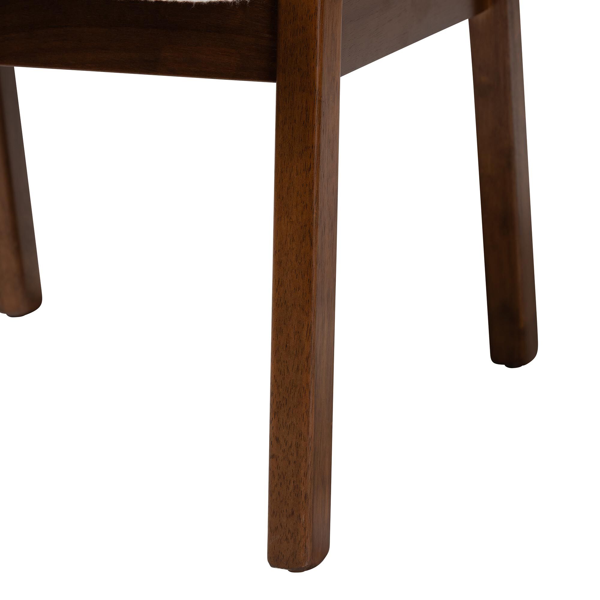 Close-up of the dark wood leg of an armchair