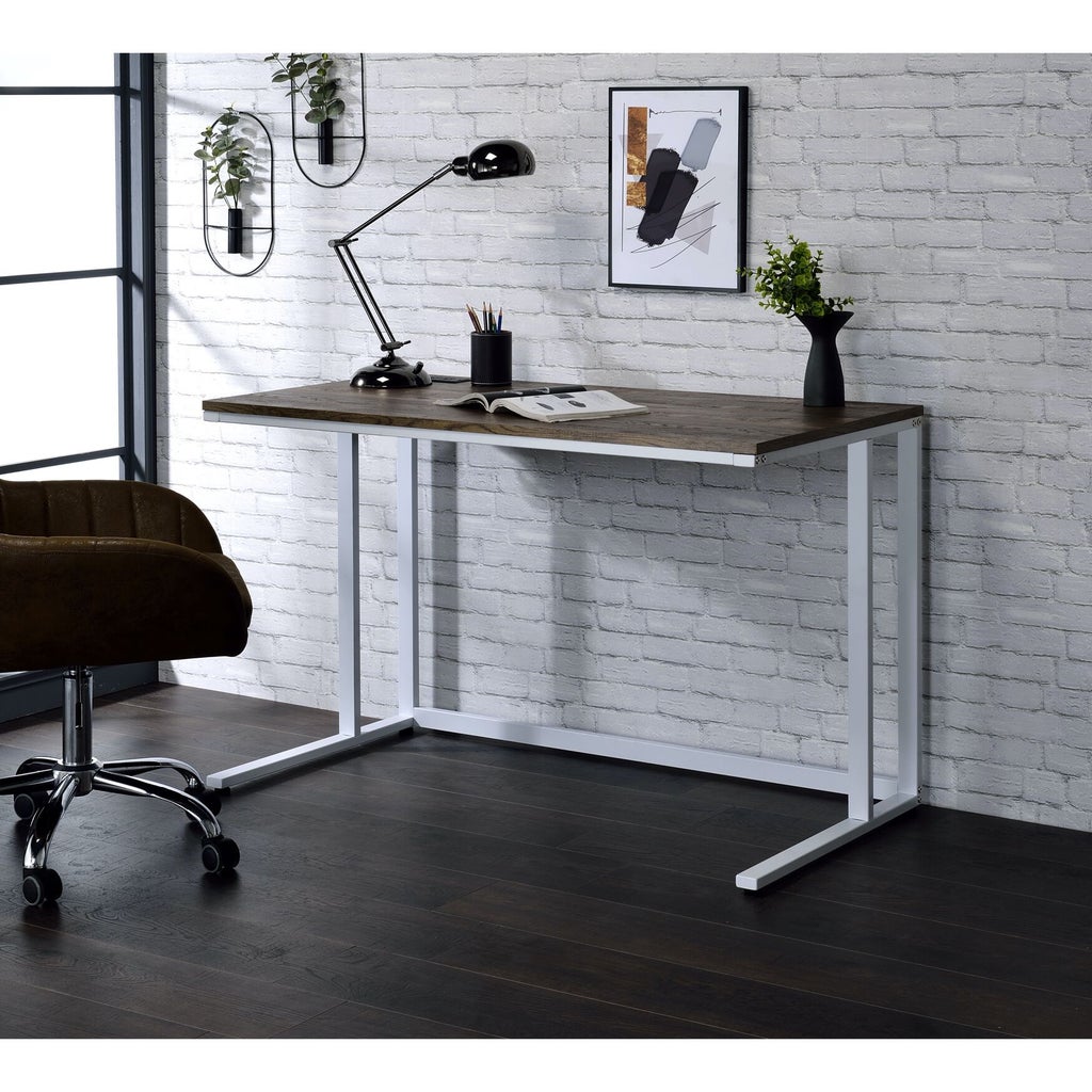 Desk in a modern home office setup with lamp and decor