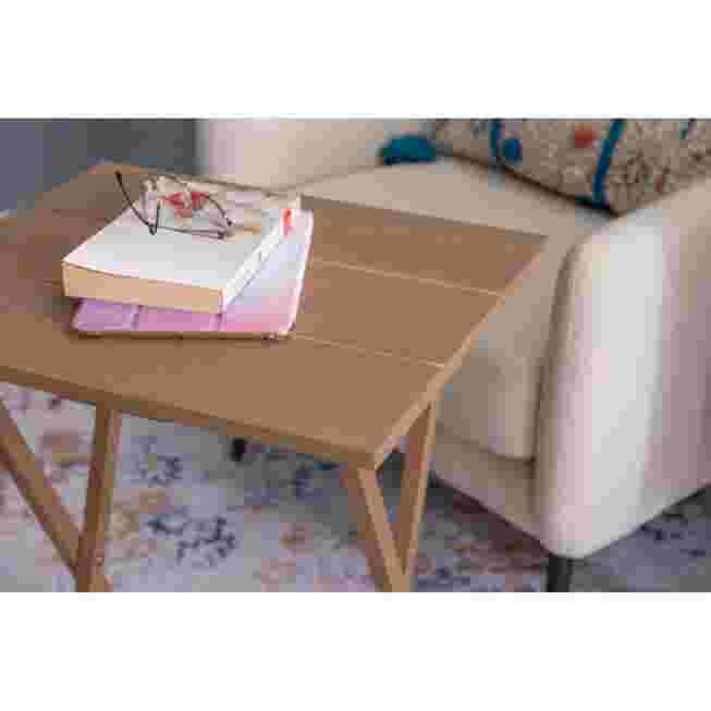 Wooden tray table with books on it in a living room