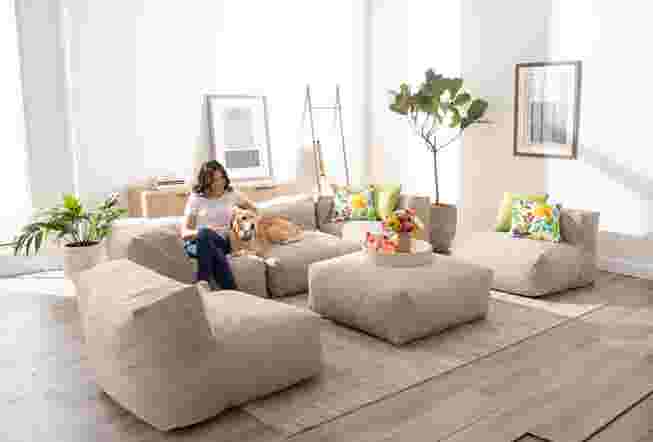 Woman sitting on patio furniture in a bright room