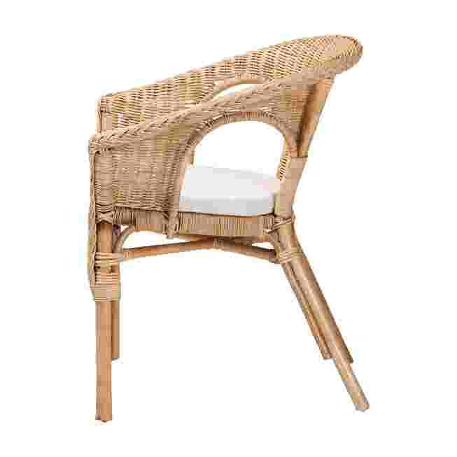 Side view of natural rattan dining chair with white cushion