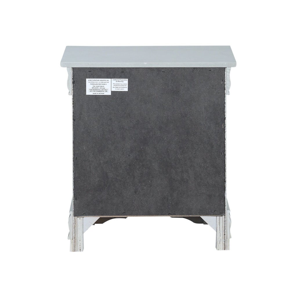 Underside view of light blue nightstand with black panel and label