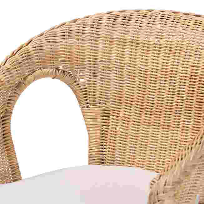 Close-up of the back and armrest of a natural rattan chair