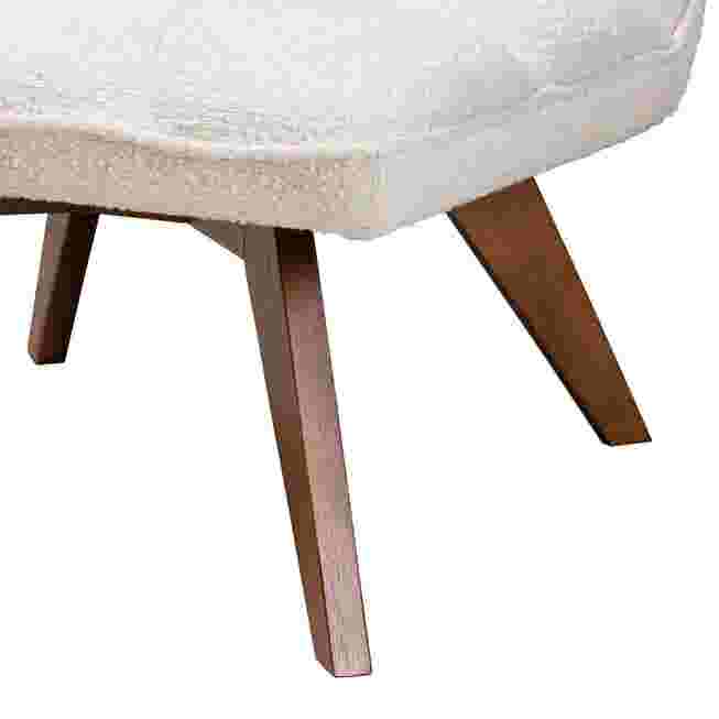Close-up of the wooden legs of a cream boucle fabric chair