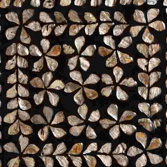 A close-up of the intricate mother of pearl inlay on a modern bohemian end table, featuring a floral pattern.