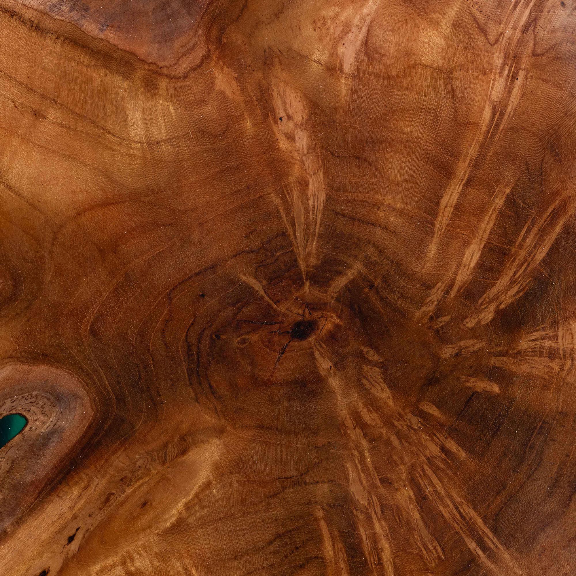 Extreme close-up of the teak wood grain and epoxy resin on the end table top
