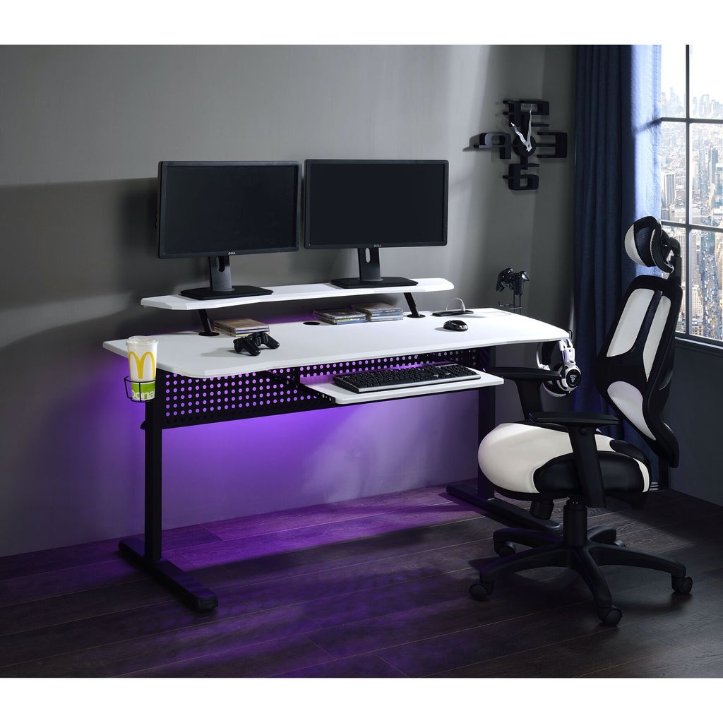 White gaming desk setup with dual monitors and purple lighting