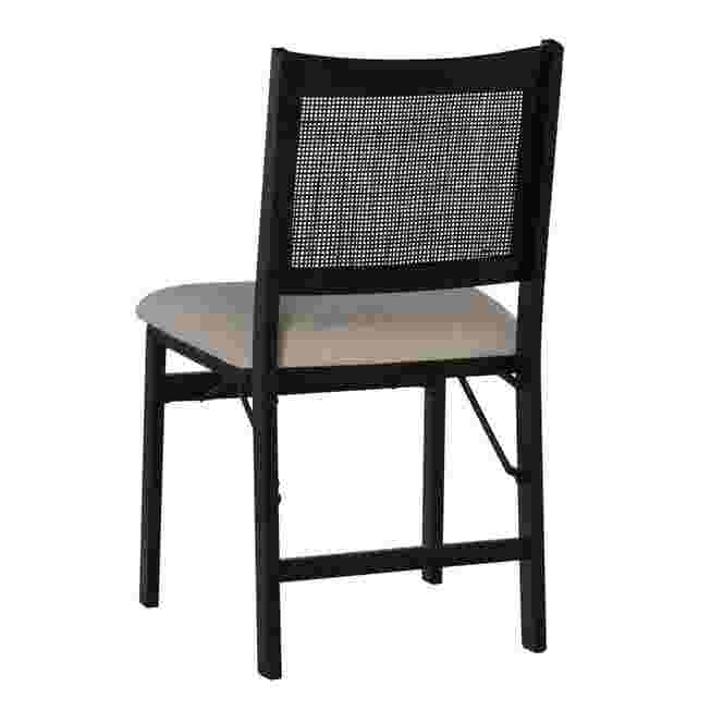 Back view of a black folding chair with a woven back and a light-colored seat cushion.