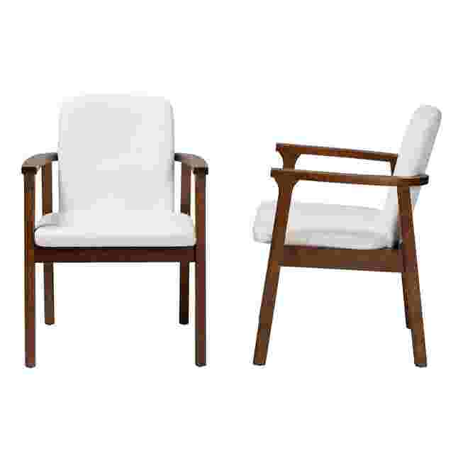 Two white upholstered armchairs with dark wood frames from different angles