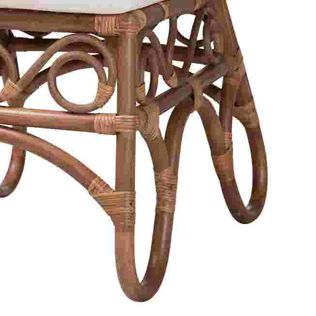 Close-up of the curved rattan legs and frame of a chair