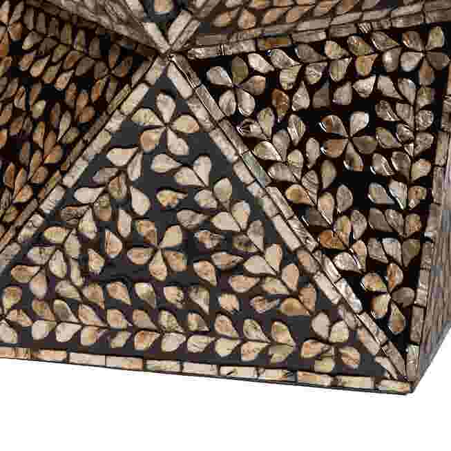 A close-up of the intricate mother of pearl inlay on a modern bohemian end table, featuring a leaf pattern.