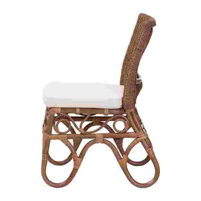 Side view of rattan dining chair with white cushion