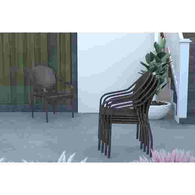 Stack of black wicker chairs on a patio