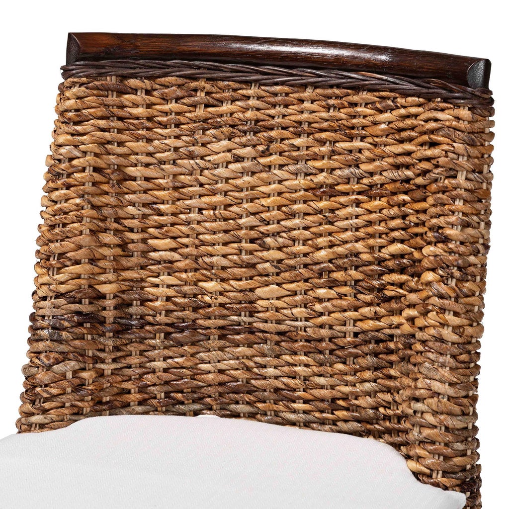 Close-up view of woven seagrass chair back texture and dark brown trim