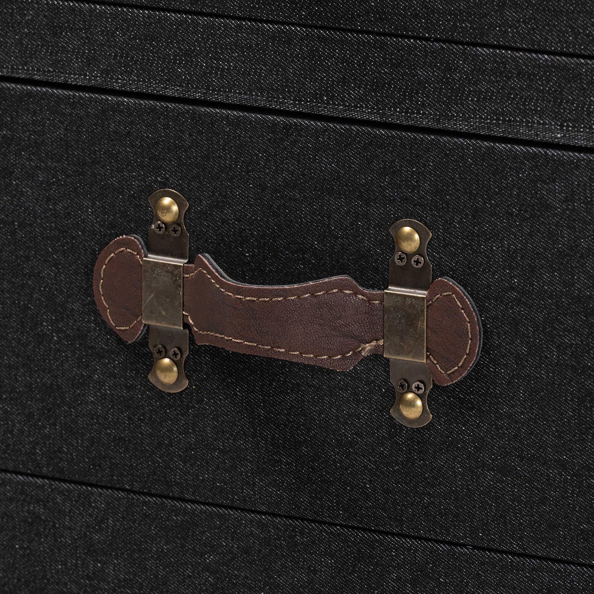 close-up of a brown leather drawer pull with brass hardware