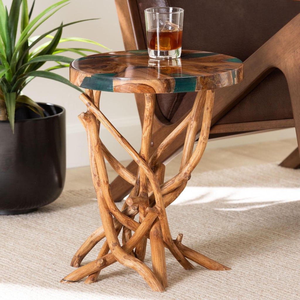 End table with a glass of whiskey on top and plant nearby in a living room
