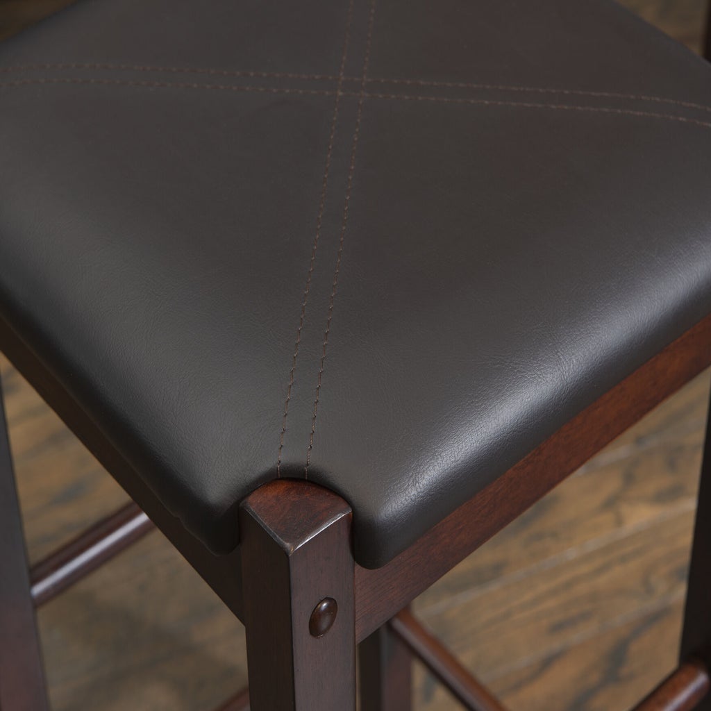 Close-up of stool corner with leather seat