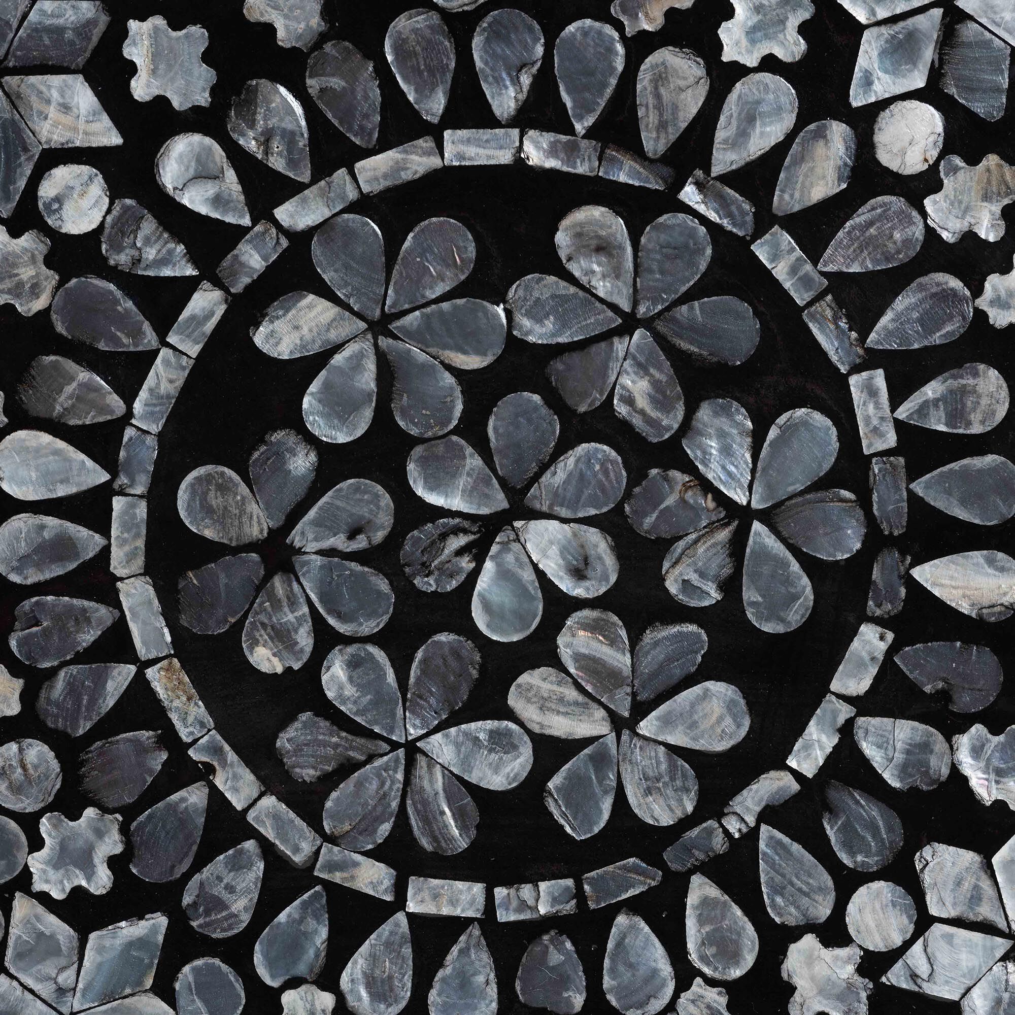 Close-up of the black and white capiz shell floral pattern on the table top.