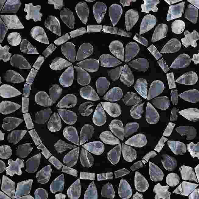 Close-up of the black and white capiz shell floral pattern on the table top.