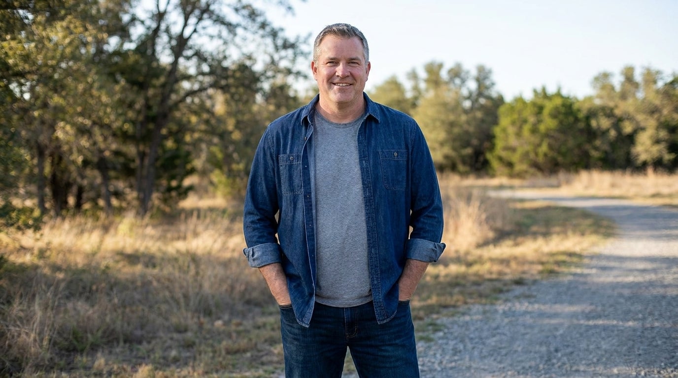 Big and tall man wearing an open denim shirt layered over a tee