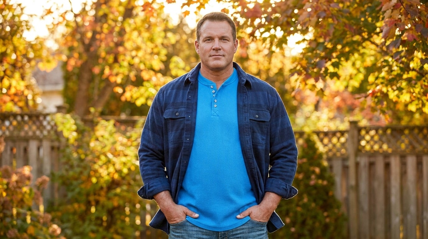 Big and Tall man wearing a waffle-knit henley layered under an open flannel shirt outdoors