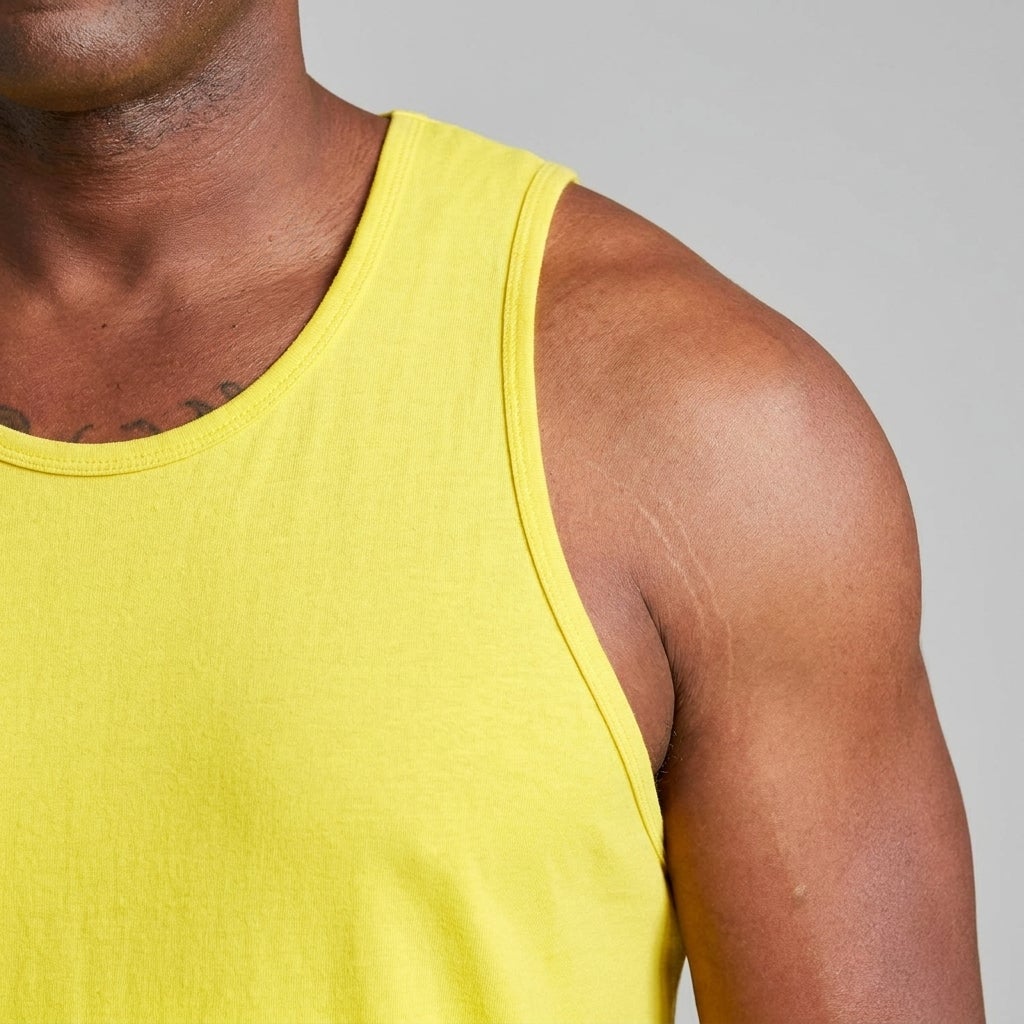 Close-up of a longer-length tank top armhole strap fitting flat on a big and tall man's shoulder