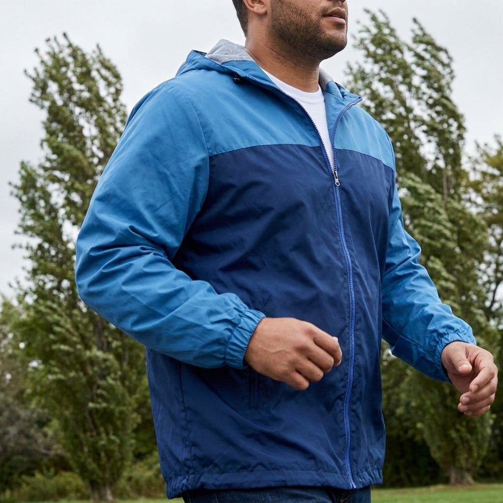 Big and tall man moving freely in a lightweight water-resistant windbreaker outdoors