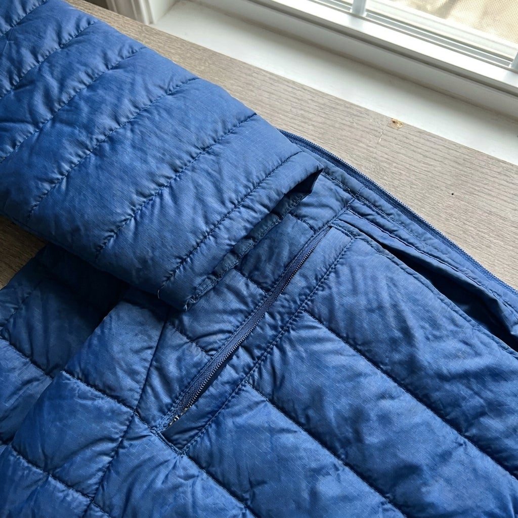 Close-up of quilted baffle stitching and interior chest pocket on a puffer jacket