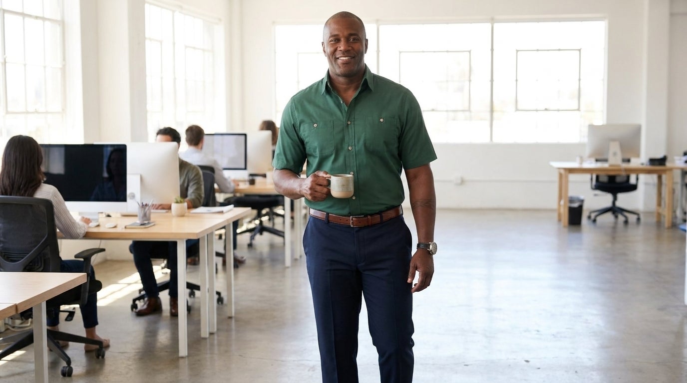 Big and Tall man in a wrinkle-resistant button-down and dress pants in a business-casual office