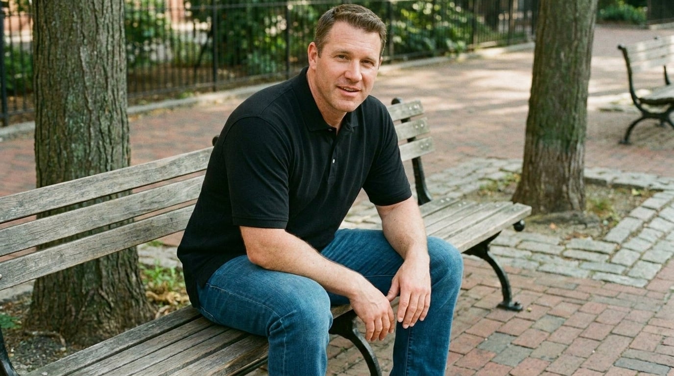Big and tall man sitting outdoors in a tucked longer-length polo that stays in place