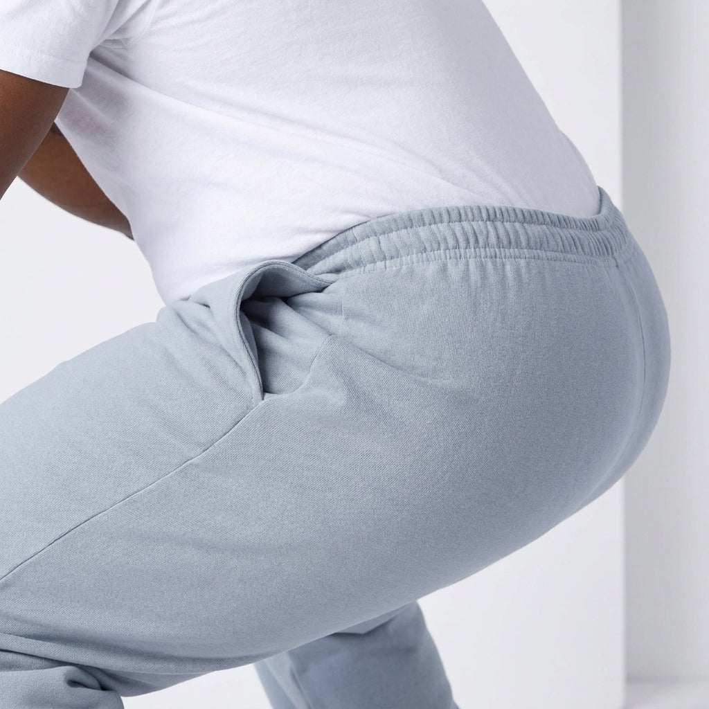 Close-up of an elastic cargo pant waistband stretched during a squat